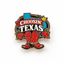 Choosin’ Texas enamel pin with red boots, roses, rope, and western design