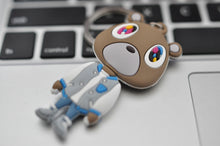 Kanye West Graduation Bear keychain displayed on laptop keyboard